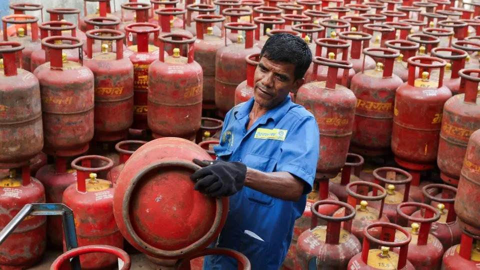 A man loads LPG cylinders onto a cart at a warehouse amid supply disruptions following the U.S.-Israeli conflict with Iran, in Mumbai, India, on March 11, 2026. - Francis Mascarenhas/Reuters