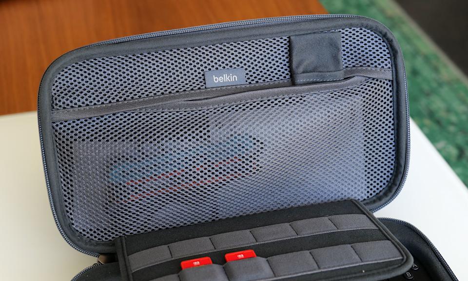 The inside of the Pro Charging Case features a handy mesh pocket, 12 slots for game carts and a hidden AirTag pouch. 