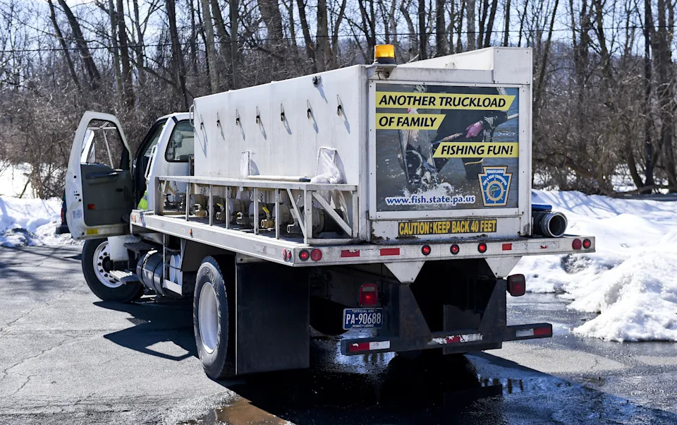 A truck with a sign on the back that reads another truckload of family fishing fun