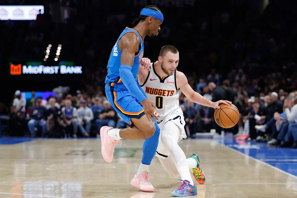 Mar 9, 2026; Oklahoma City, Oklahoma, USA; Denver Nuggets guard Christian Braun (0) moves the ball around Oklahoma City Thunder guard Shai Gilgeous-Alexander (2) during the second quarter at Paycom Center. Mandatory Credit: Alonzo Adams-Imagn Images