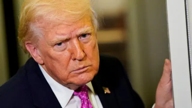 Donald Trump hand a hand on a door on Air Force One