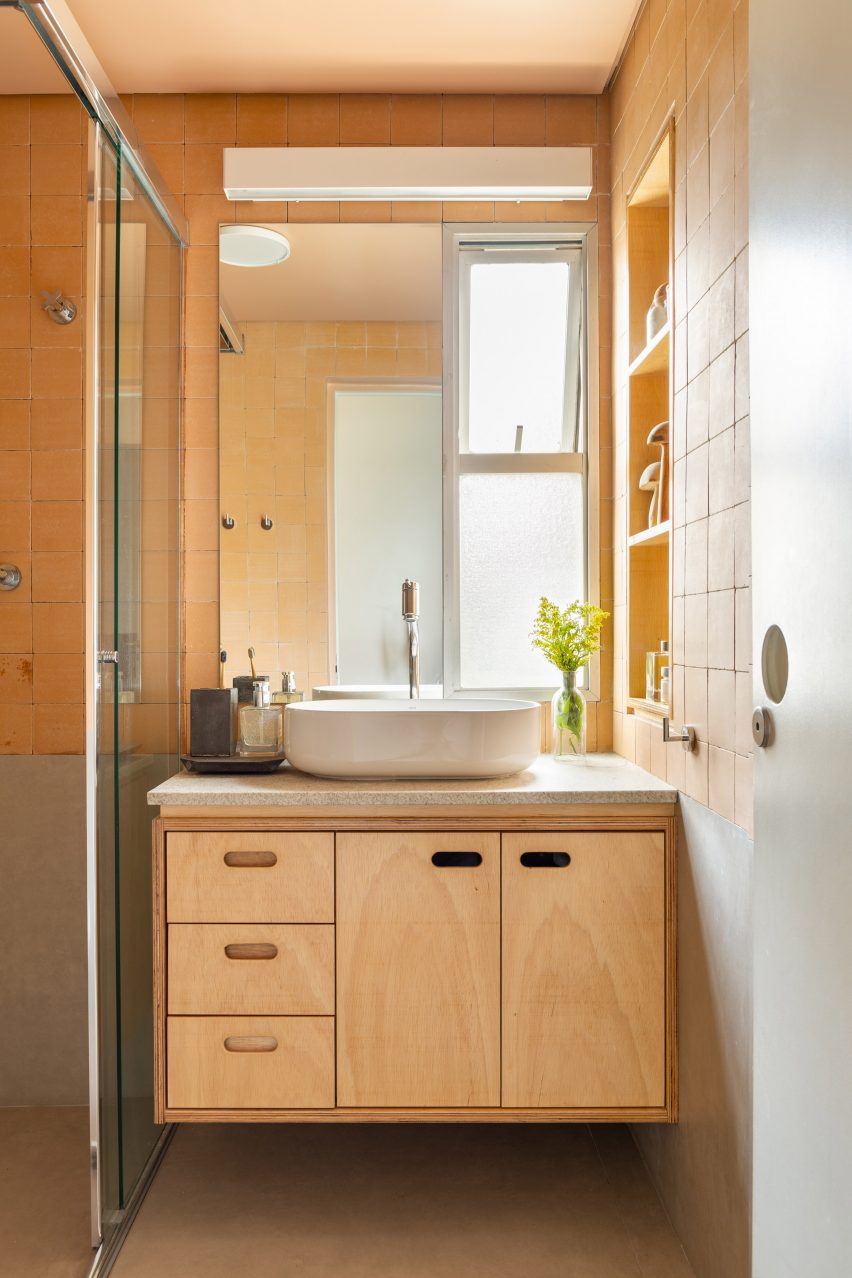 Bathroom with concrete and terracotta tile walls