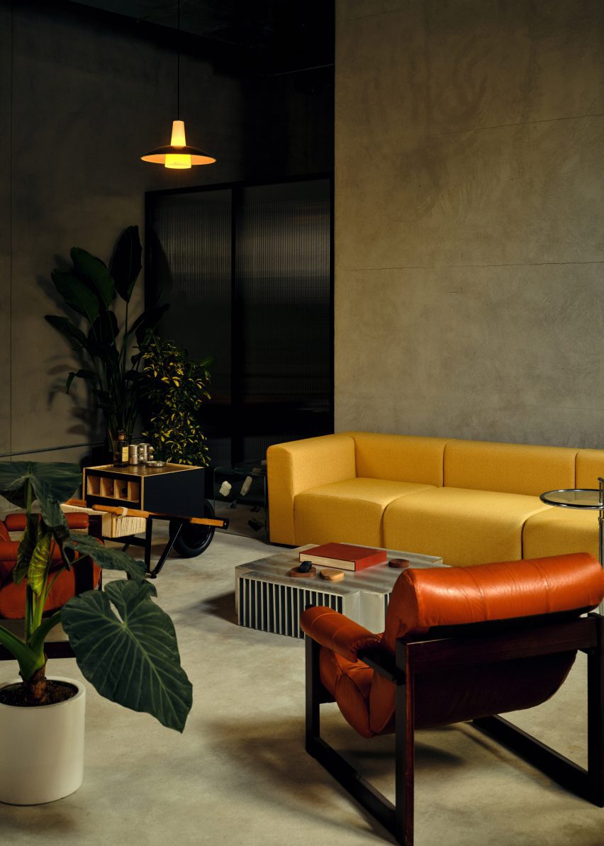 A lounge area including a custom bar cart modelled on a Alvar Aalto design and a coffee table resembling a car grille