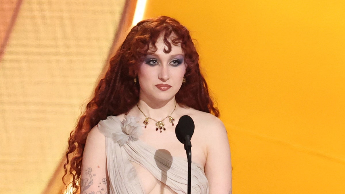 Chappell Roan standing on a stage and presenting an award.