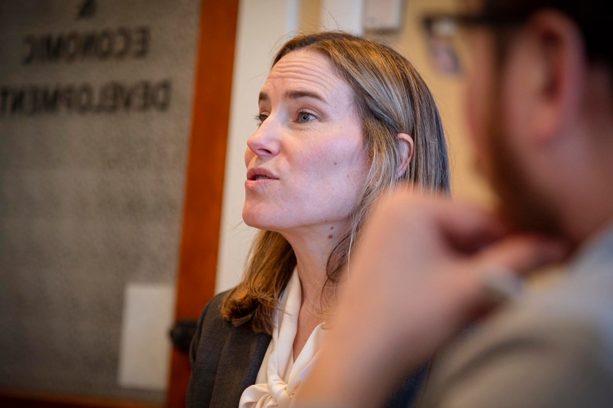 A woman in a business suit talking.