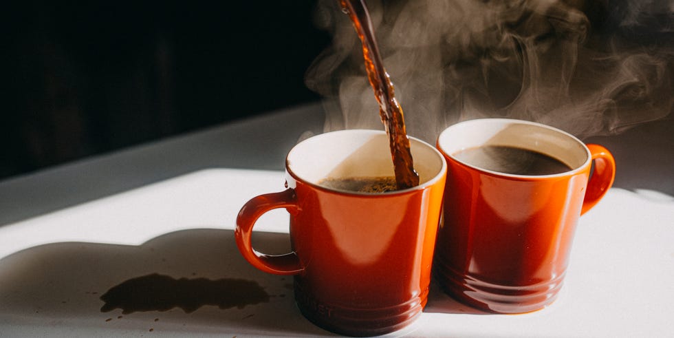 coffee pouring in two mugs