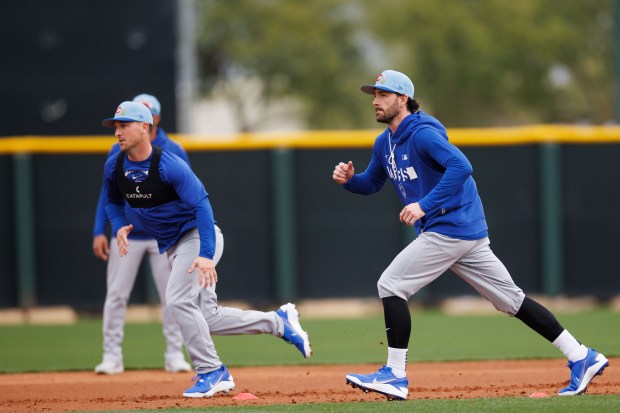 Alex Bregman, left, and Dansby Swanson run drills during a Cubs spring training workout at Sloan Park on Feb. 16, 2026, in Mesa, Ariz. (Armando L. Sanchez/Chicago Tribune)