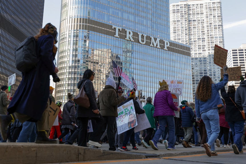 Demonstrators walk past the Trump Tower during a "No Kings" protest.