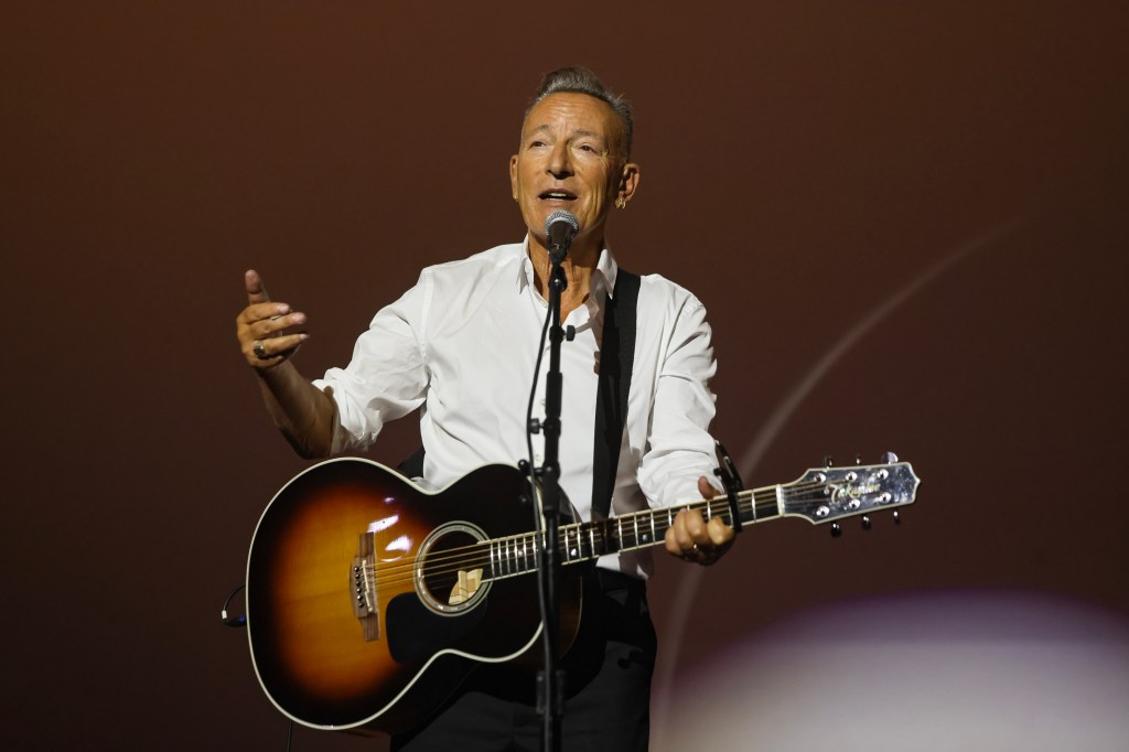 Bruce Springsteen performing with an acoustic guitar at the AFI FEST premiere of "Springsteen: Deliver Me From Nowhere."