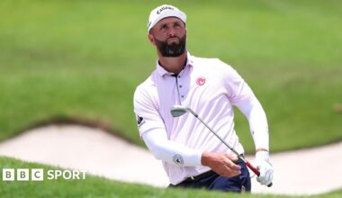 Jon Rahm chips out of a bunker