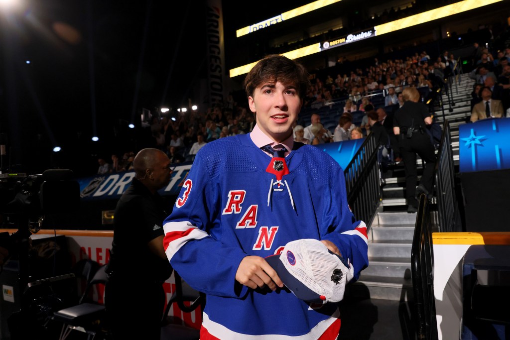 Drew Fortescue, wearing a New York Rangers jersey, celebrates after being selected 90th overall pick during the 2023 Upper Deck NHL Draft.