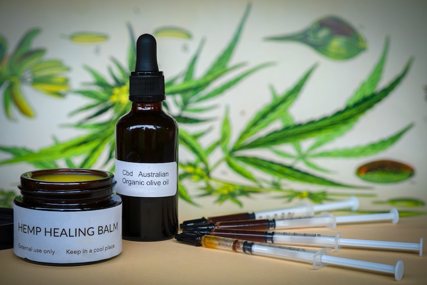 A bottle with dropper, an ointment jar and syringes labelled as containing medicinal hemp products.