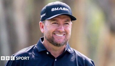 A smiling Graeme McDowell wears a dark cap and open-necked shirt
