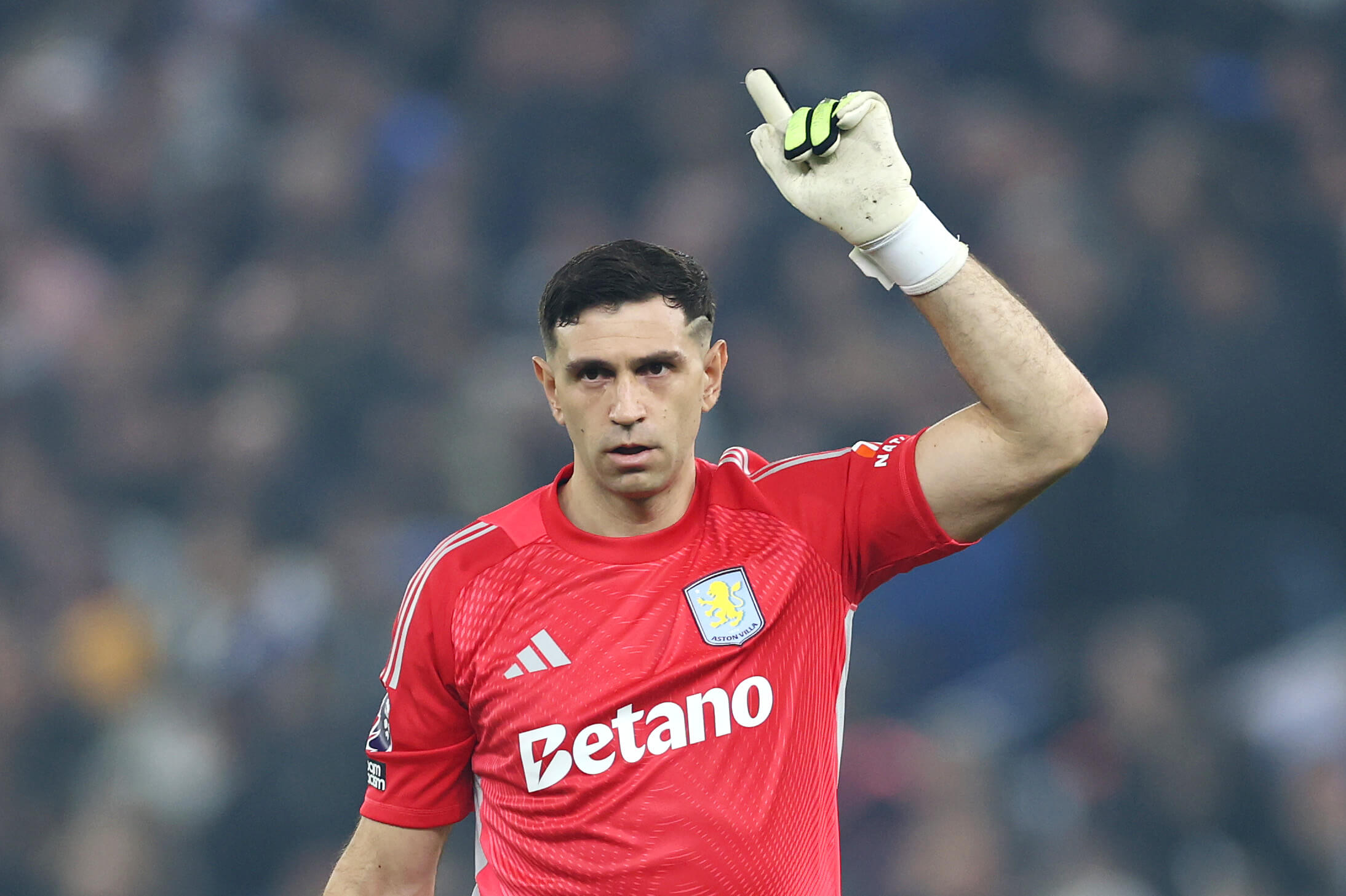 Martinez pointing to the sky while playing for Villa