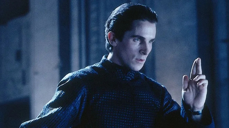 John Preston (Christian Bale) solemnly holds up two fingers in Equilibrium