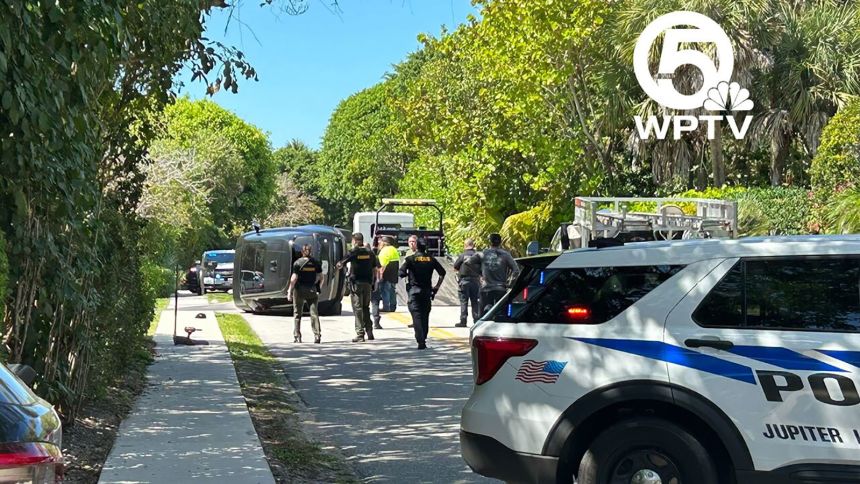 A photo from CNN affiliate WPTV shows a Range Rover on its side at the scene where authorities say Tiger Woods was involved in a rollover crash on Jupiter Island, Florida, on Friday, March 27.