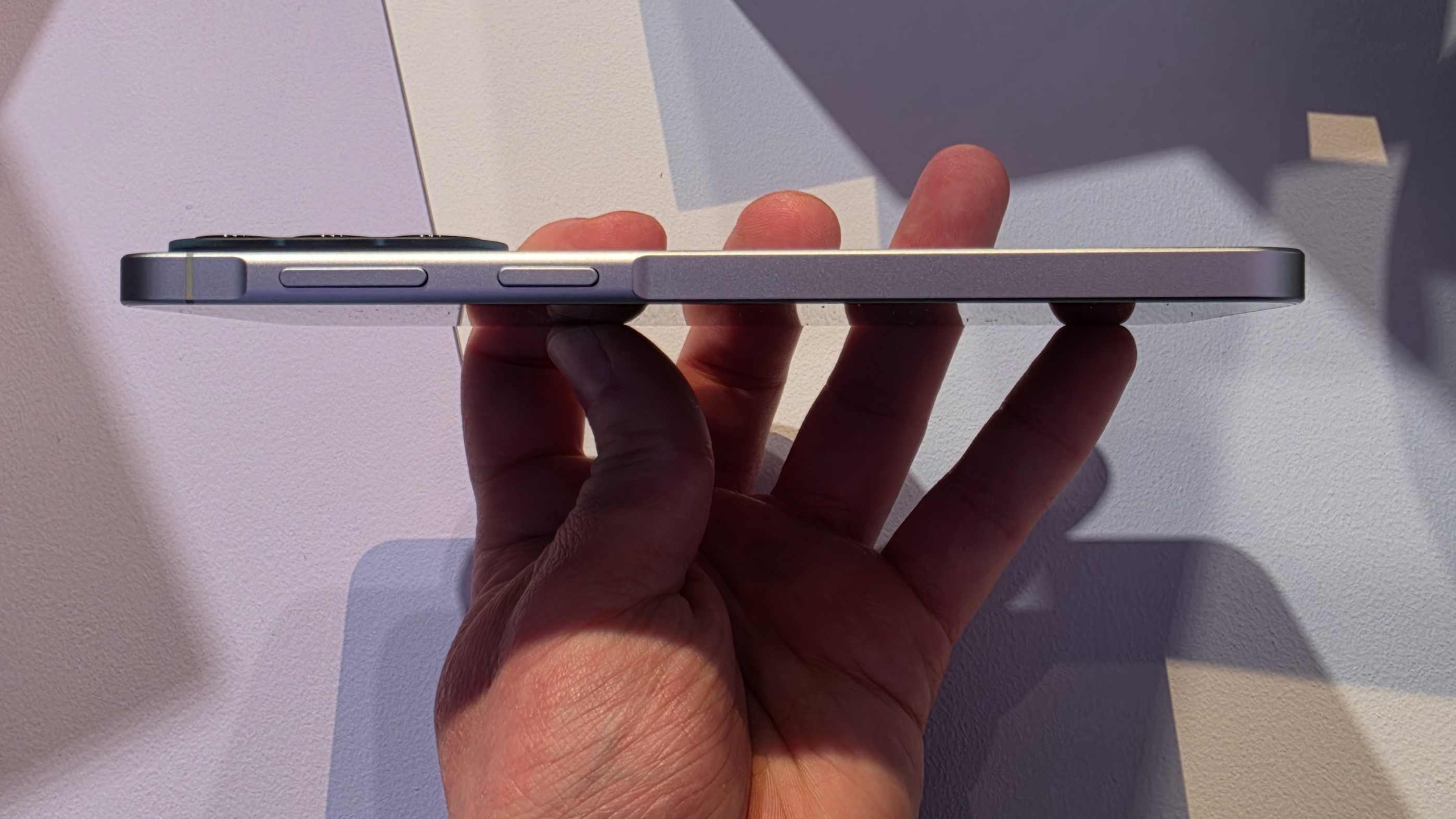 The Samsung Galaxy A57's edge, while it's held in a man's hand.