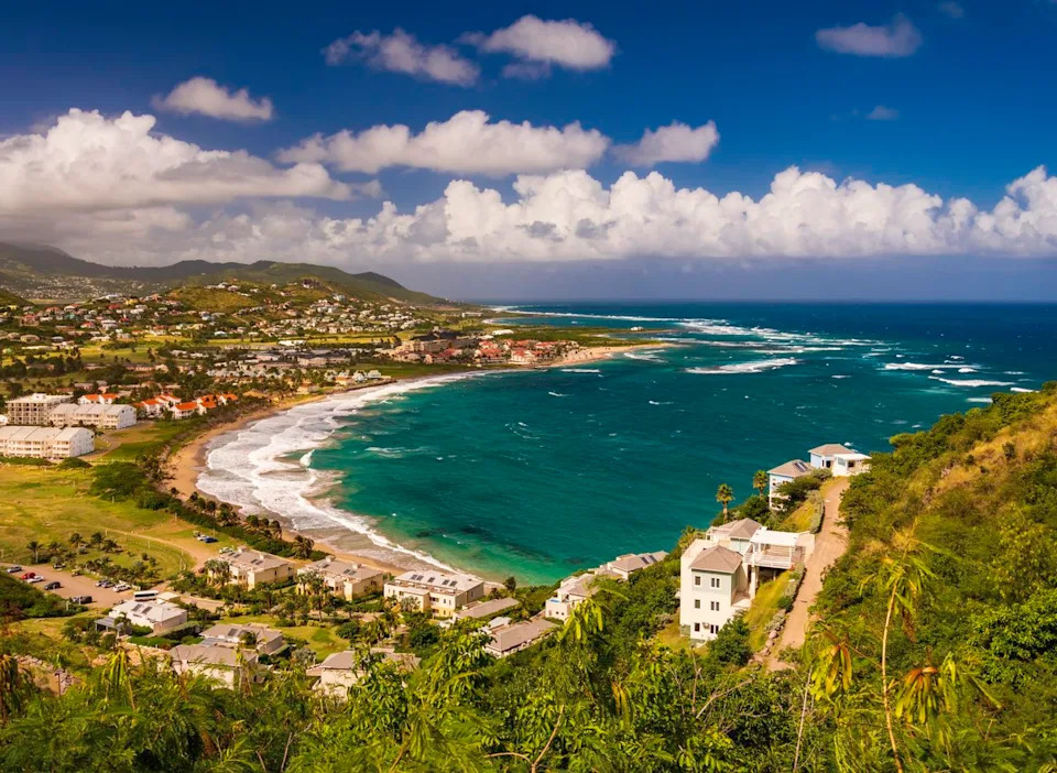 The view from Timothy Hill reveals Frigate Bay's unique geography—where the Atlantic Ocean meets the Caribbean Sea on one of the region's safest and most upscale islands.Credit: allou / Getty Images
