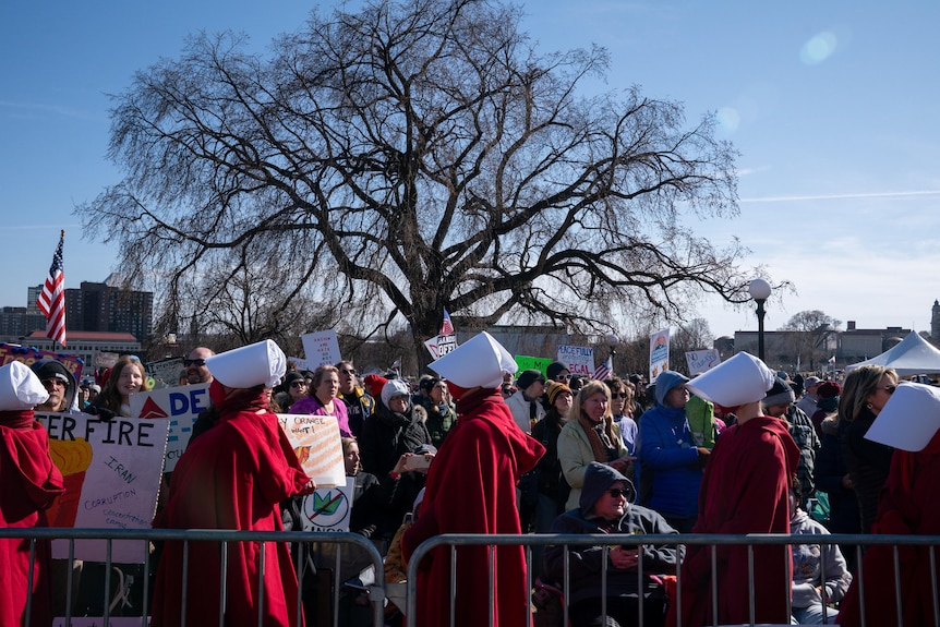 Women dressed as handmaids congregated at the Minnesota State Capitol.
