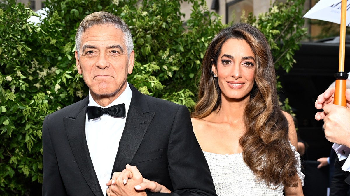George Clooney holds wife Amal Clooney's hand at Tony Awards