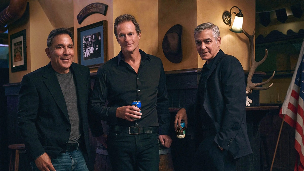 George Clooney, Mike Meldman and Rande Gerber posing with Crazy Mountain beer cans