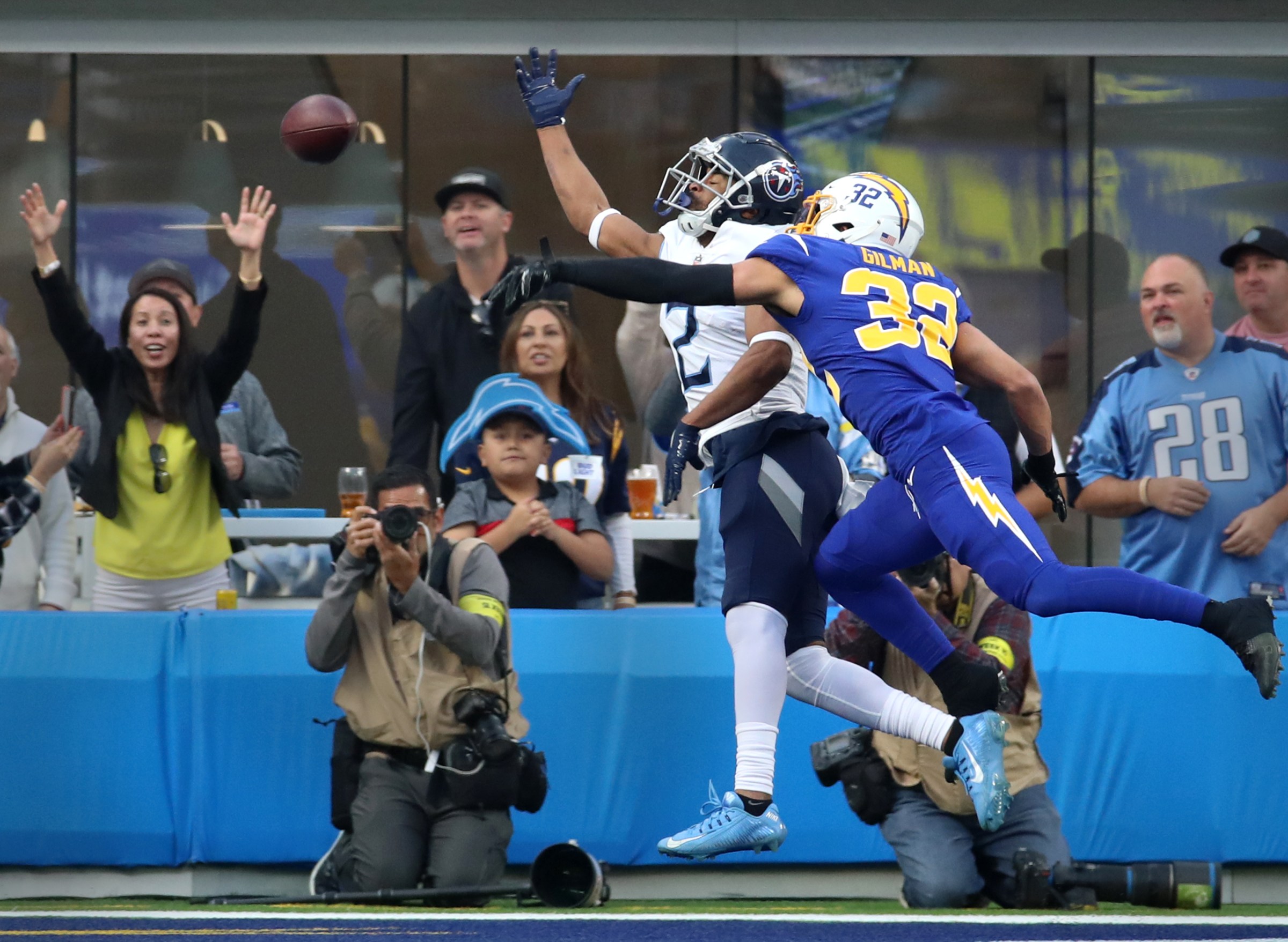 Inglewood, CA - December 18: Los Angeles Chargers safety Alohi Gilman, #32, right, pressures Titans wide receiver Robert Woods during an incomplete pass in end zone in the second half at SoFi Stadium on Sunday, Dec. 18, 2022 in Los Angeles, CA.(Allen J. Schaben / Los Angeles Times via Getty Images)