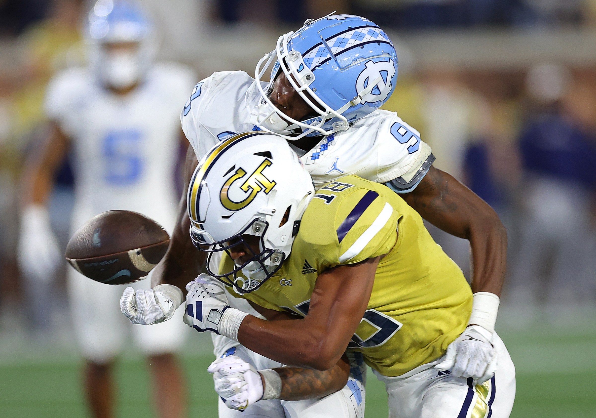 ATLANTA, GEORGIA - OCTOBER 28: Ahmari Harvey #18 of the Georgia Tech Yellow Jackets forces a turnover as he tackles Devontez Walker #9 of the North Carolina Tar Heels during the fourth quarter at Bobby Dodd Stadium on October 28, 2023 in Atlanta, Georgia. (Photo by Kevin C. Cox/Getty Images)