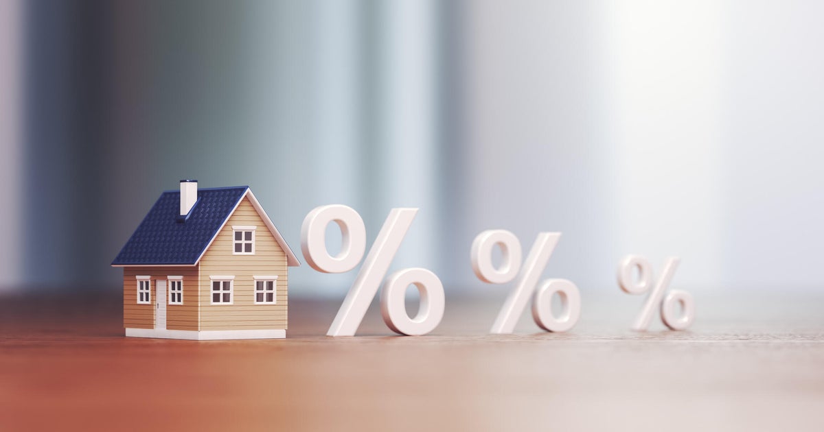 Miniature house Real Estate Trading and Percentage Signs, Mortgage Low and High Interest Concept Buying and Selling