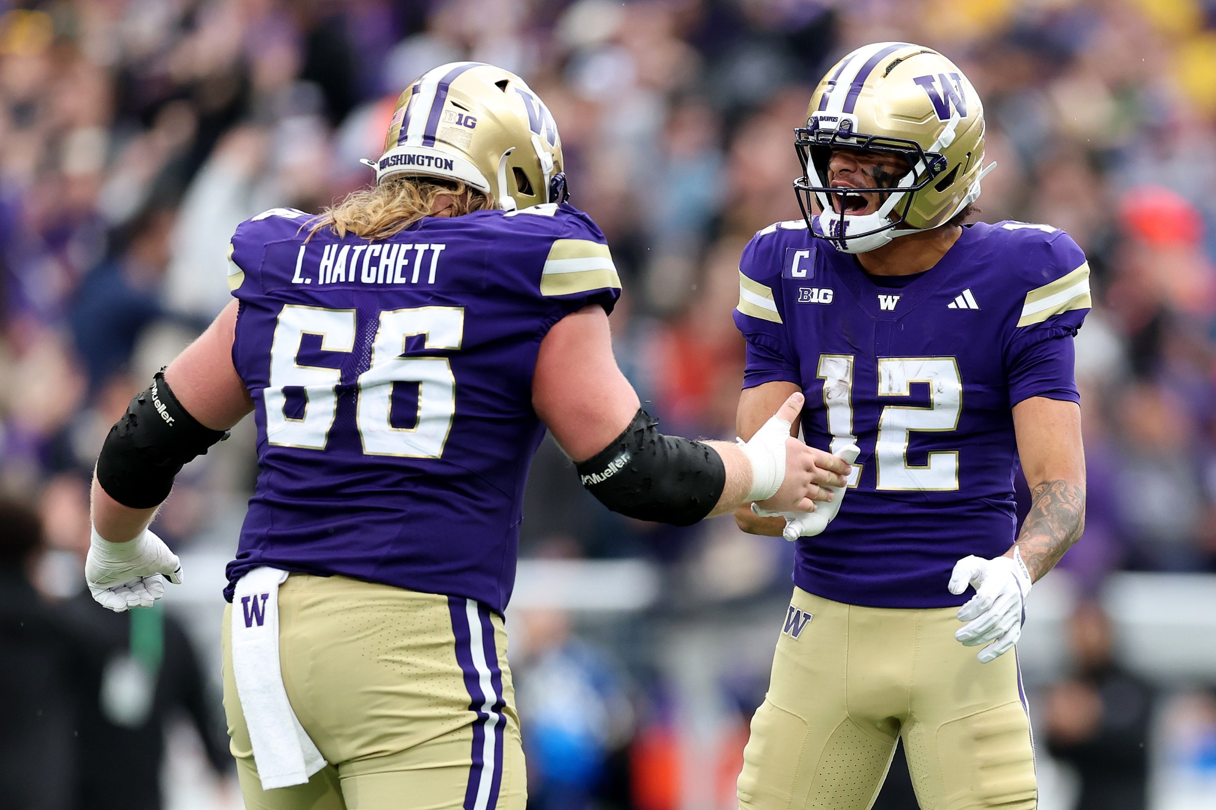 SEATTLE, WASHINGTON - OCTOBER 25: Landen Hatchett #66 and Denzel Boston #12 of the Washington Huskies celebrate a touchdown against the Illinois Fighting Illini at Husky Stadium on October 25, 2025 in Seattle, Washington. (Photo by Steph Chambers/Getty Images)