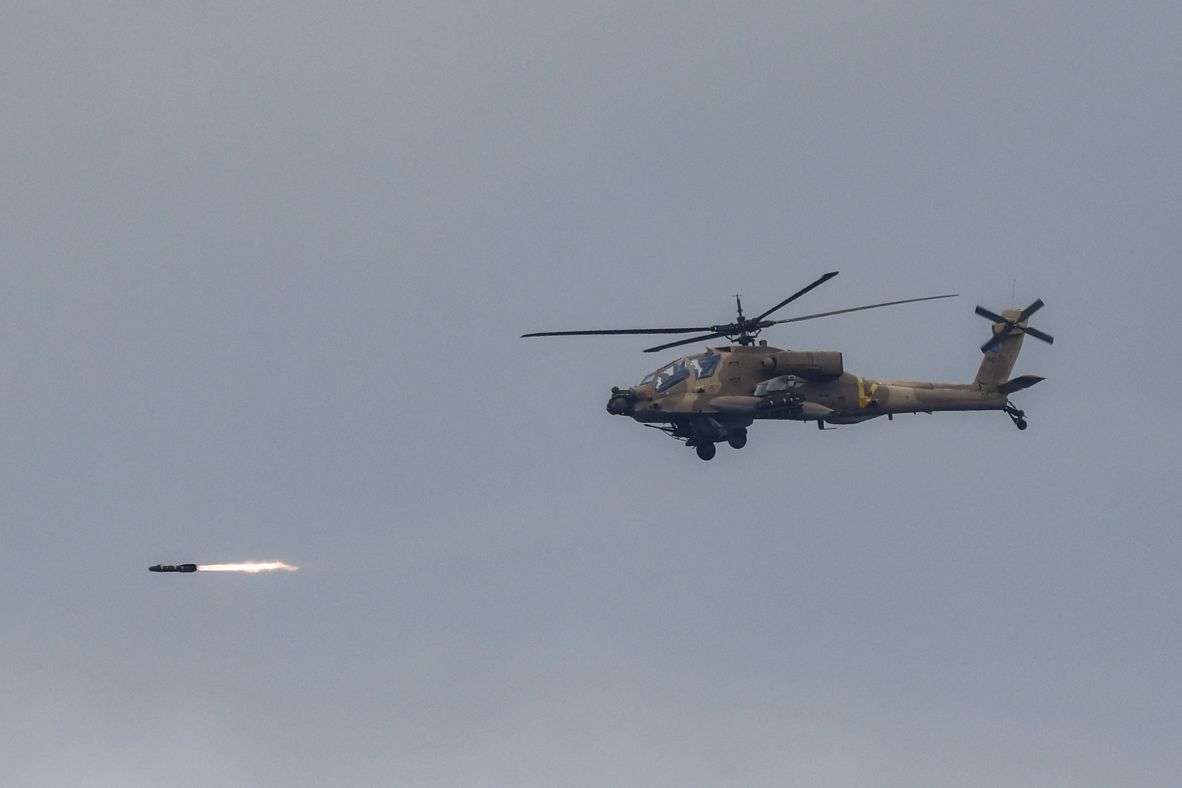 An Israeli helicopter fires while flying along the border between northern Israel and southern Lebanon on Wednesday.
