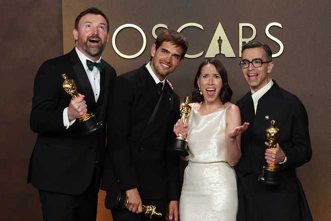(L/R) After a tie in the category, US filmmakers Jack Piatt and Sam Davis hold the Oscar for best Best Live Action Short Film for "The Singers" alongside US filmmaker Alexandre Singh and US curator Natalie Musteata with their Oscar for best Best Live Action Short Film for "Two People Exchanging Saliva" in the press room during the 98th Annual Academy Awards at the Dolby Theatre in Hollywood, California on March 15, 2026. (Photo by VALERIE MACON / AFP via Getty Images)