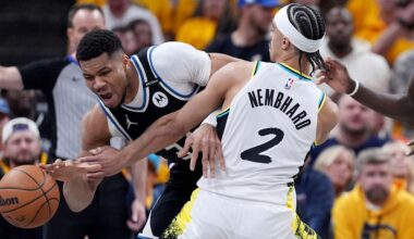Milwaukee Bucks' Giannis Antetokounmpo, left, dribbles as Indiana Pacers' Andrew Nembhard (2) defends during the first half of a first-round NBA basketball playoff game, Saturday, April 19, 2025, in Indianapolis. (AP Photo/Michael Conroy)