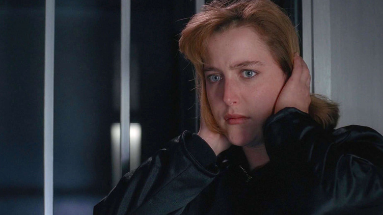 Gillian Anderson as Dana Scully blocking her ears in The X-Files