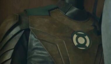 shot of a Green Lantern suit hanging in a closet with the lantern logo visible on the front.