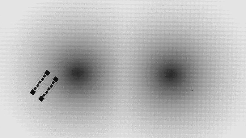 Microscopic swimming robots navigate 'artificial space-time' mazes using Einstein's relativity