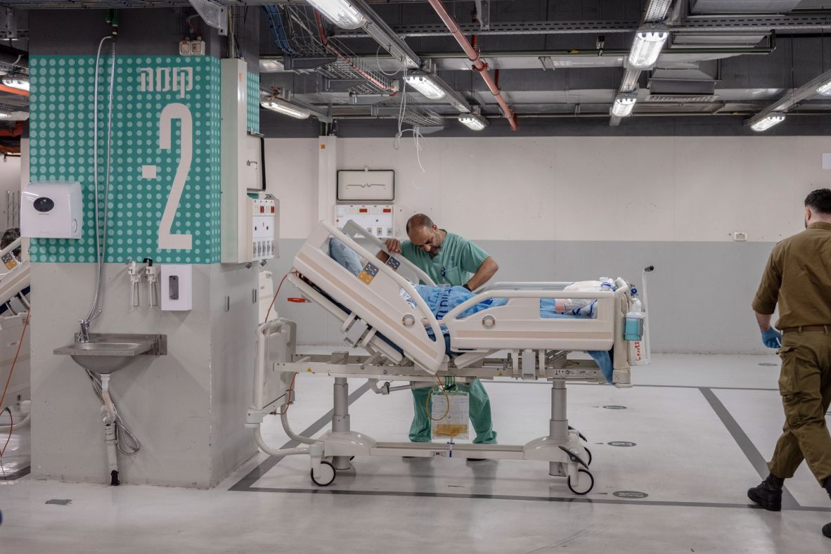 Staff members transfer patients to an underground shelter at the Ichilov hospital in Tel Aviv, Israel, following an air raid warning on February 28.