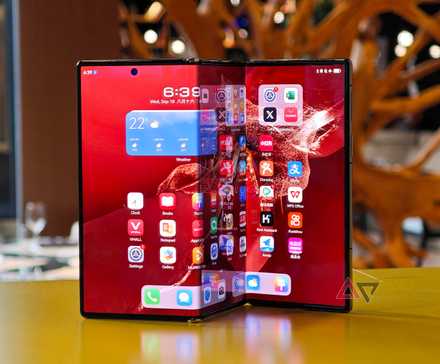 The Huawei Mate XT standing on a table in the unfolded position