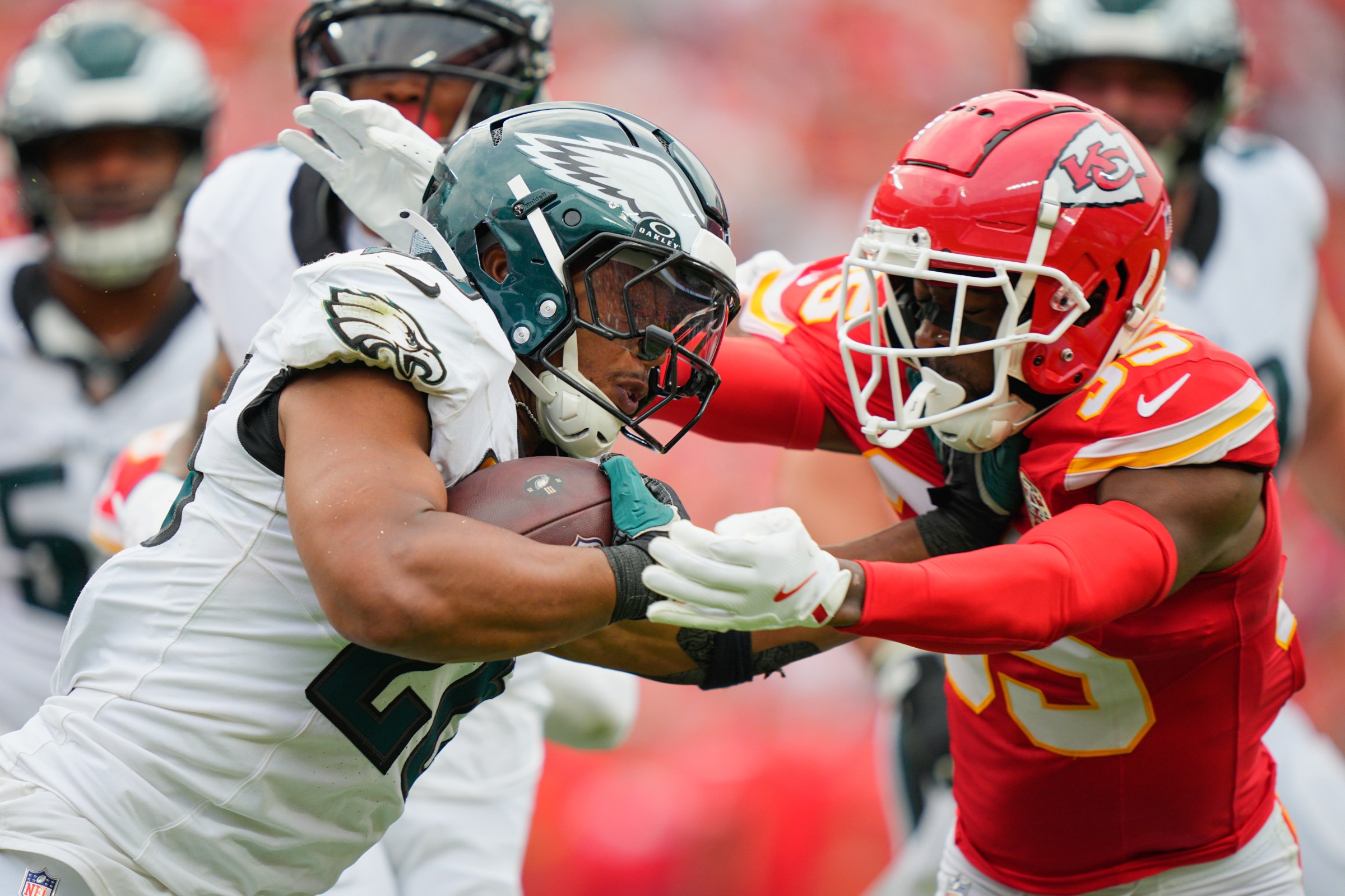 Sep 14, 2025; Kansas City, Missouri, USA; Kansas City Chiefs defensive tackle Omarr Norman-Lott (55) tackles Philadelphia Eagles running back Saquon Barkley (26) during the third quarter of the game at GEHA Field at Arrowhead Stadium. Mandatory Credit: Jay Biggerstaff-Imagn Images