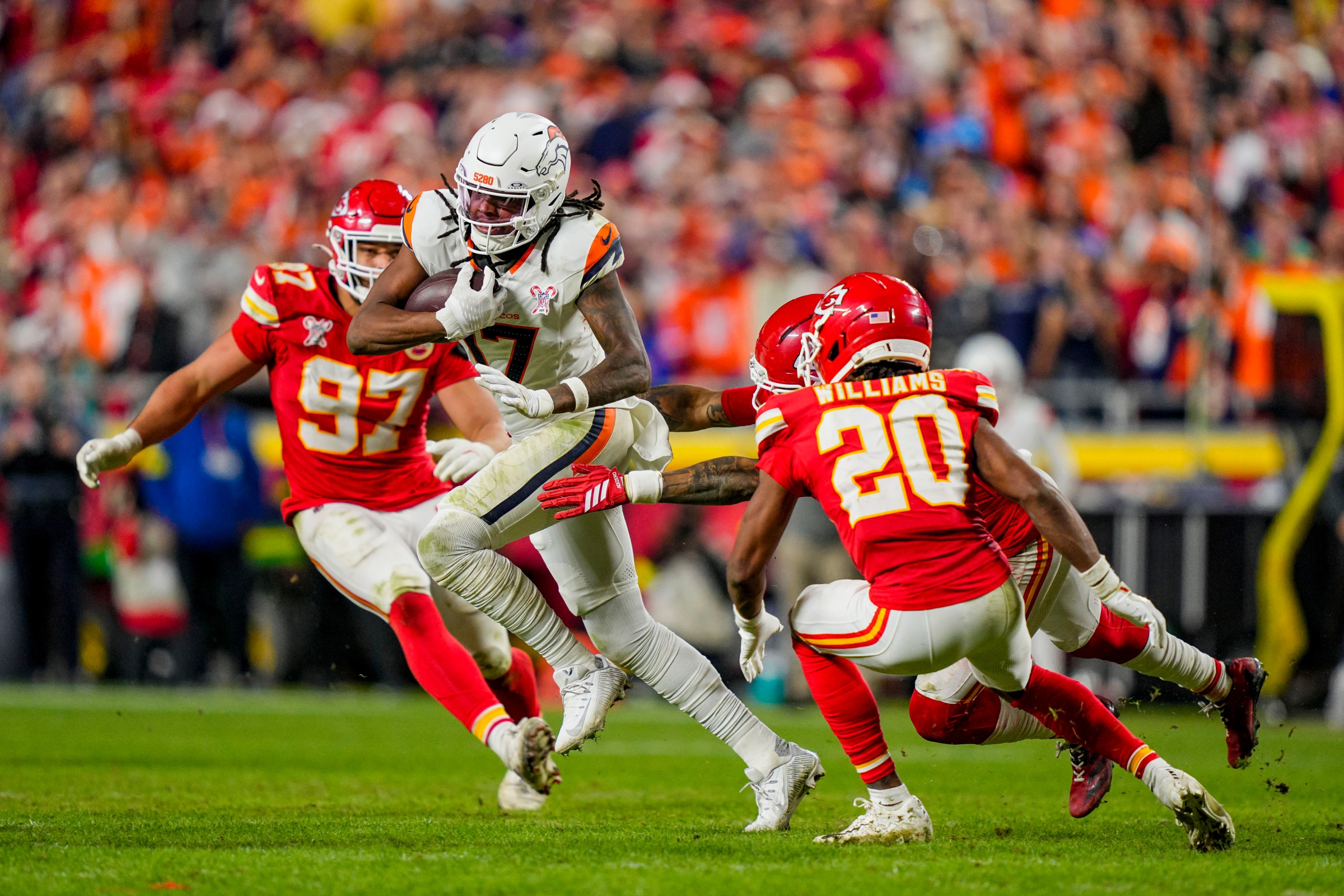 Dec 25, 2025; Kansas City, Missouri, USA; Denver Broncos wide receiver Lil’Jordan Humphrey (17) runs against Kansas City Chiefs cornerback Nohl Williams (20) and Kansas City Chiefs defensive end Ashton Gillotte (97) during the fourth quarter at GEHA Field at Arrowhead Stadium. Mandatory Credit: Jay Biggerstaff-Imagn Images