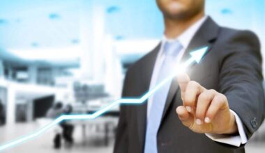 Businessman touching a digital touchscreen with an overlaid increasing trendline