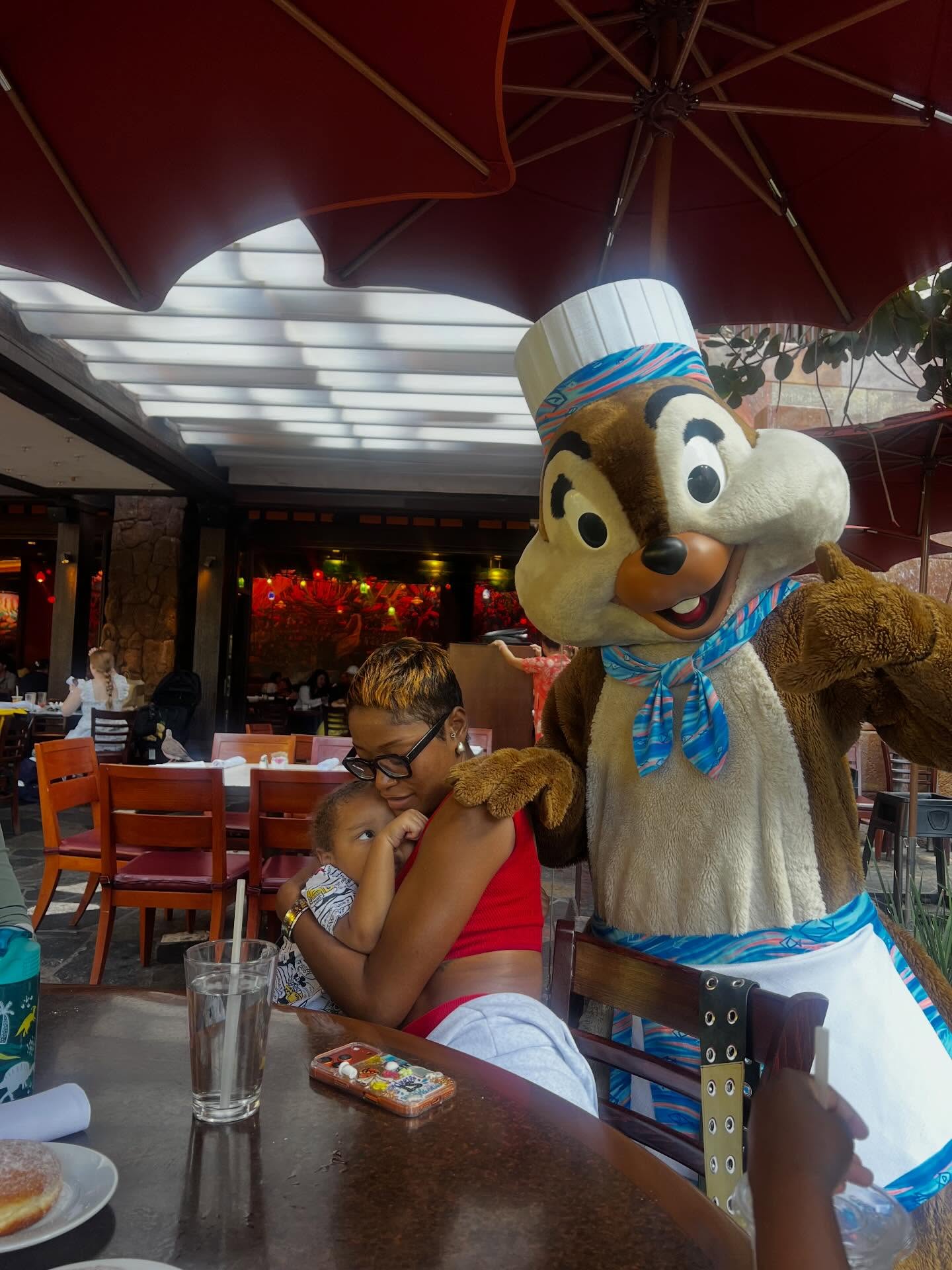 Keke Palmer (center) consoles her 3-year-old son, Leo, who’s scared of Chip, at Disney Aulani Resort in Hawaii.