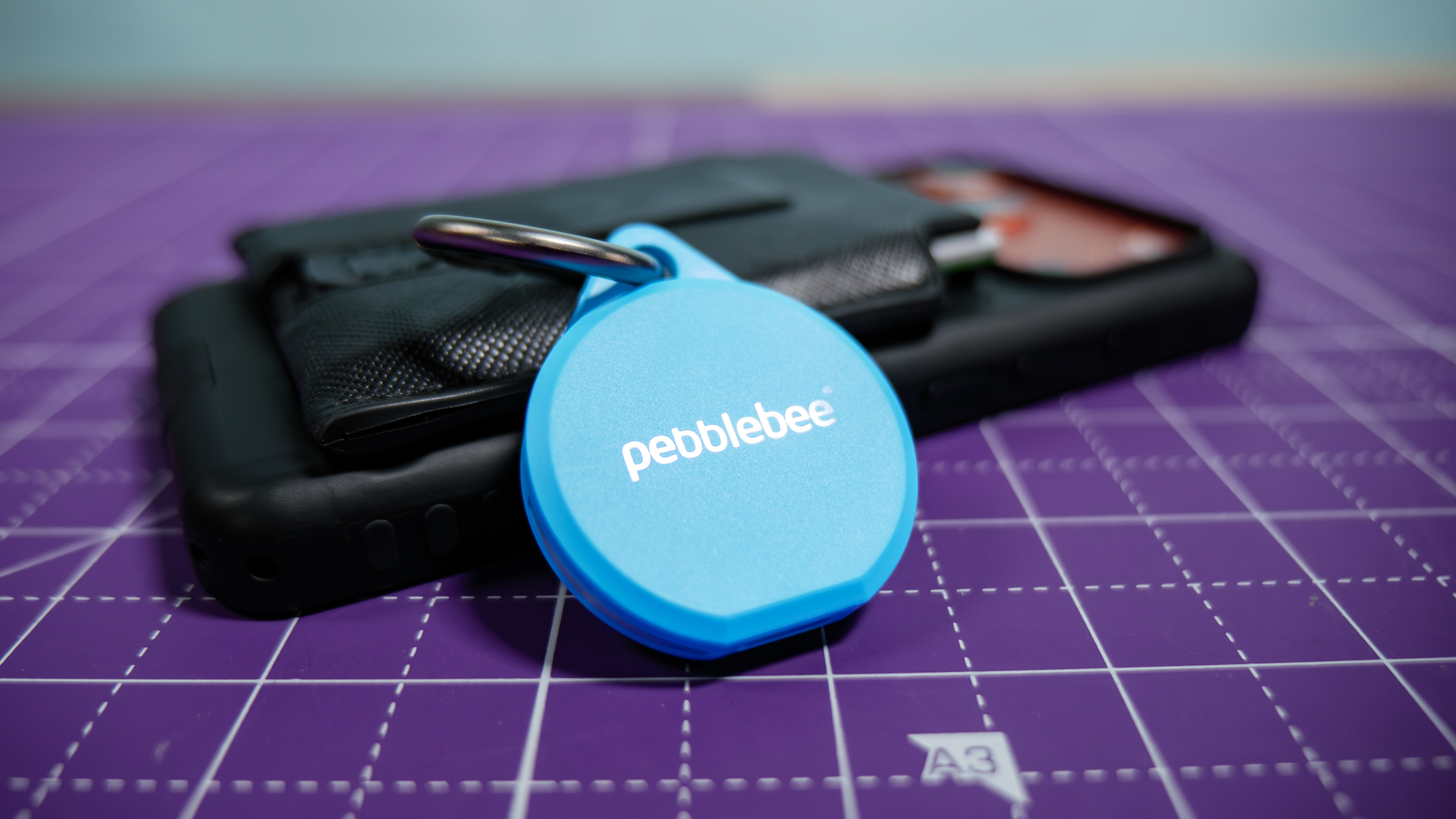 Pebblebee Clip 5 held in the hand.