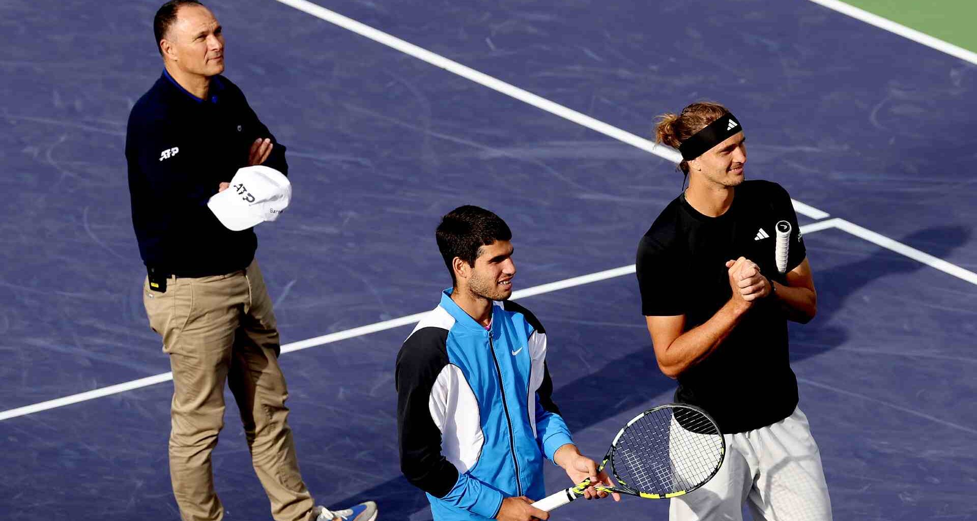 Umpire Mohamed Lahyani, Carlos Alcaraz and Alexander Zverev all wait while play is halted due to a bee invasion at Indian Wells in 2024.