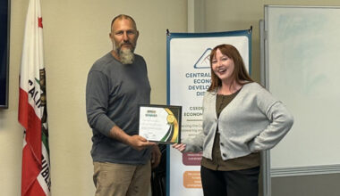 (left to right) RJ Skaar being presented the microgrant by Sophia Kaufman, who organized the event—Central Sierra Biomass Business Competition photo