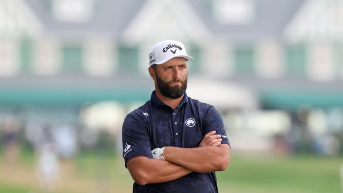 jon rahm with his arms crossed
