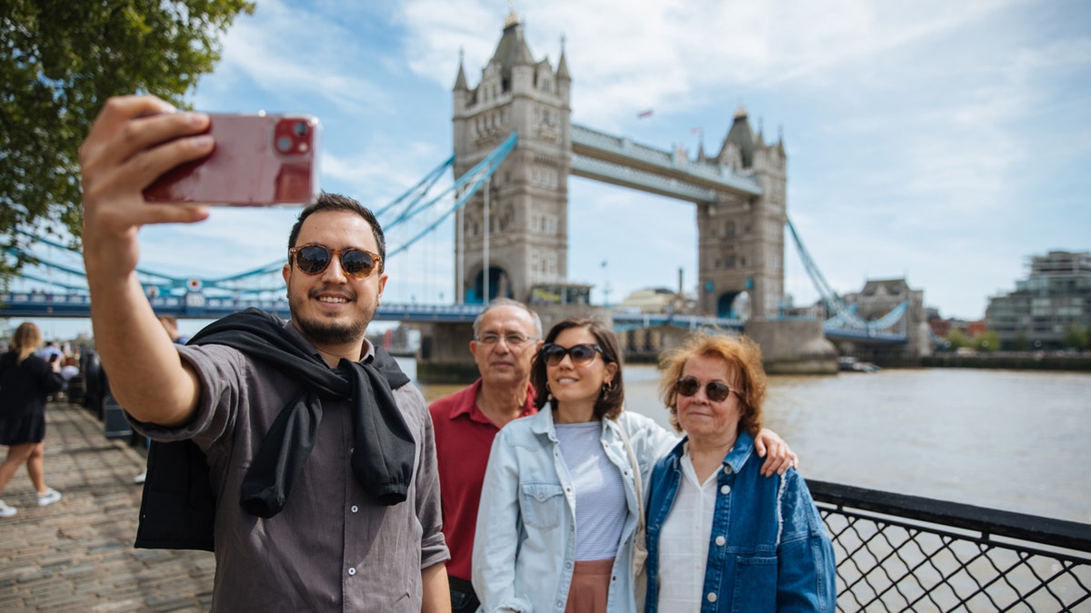four tourists taking selfie in london