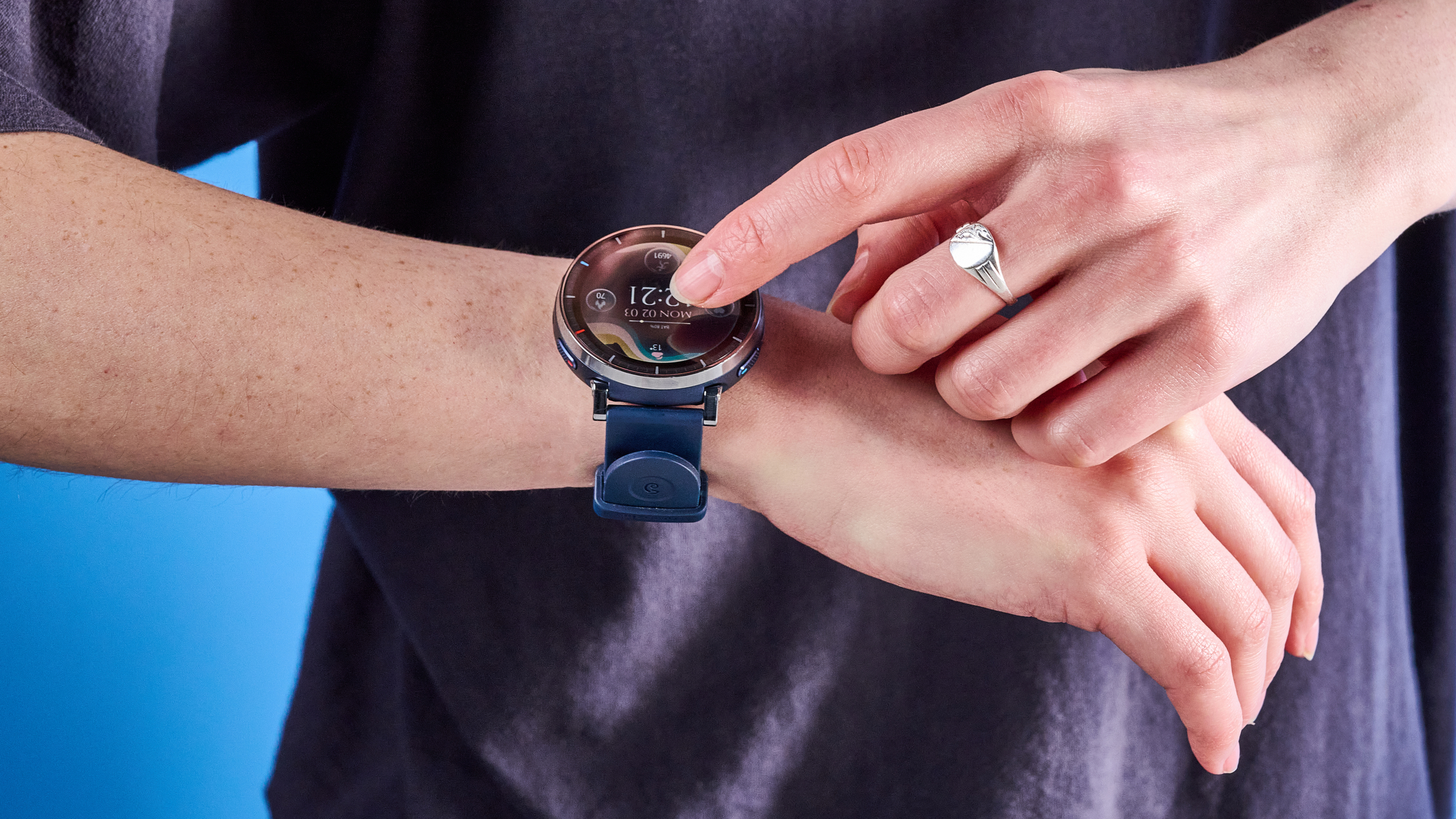 the amazfit active 3 premium photographed against the blue tom's guide background