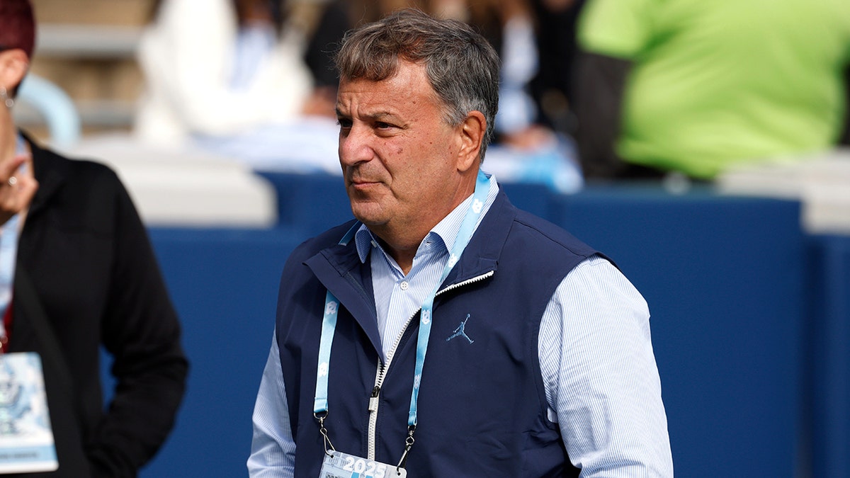 Michael Lombardi looks on