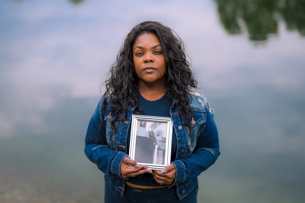 Ste’Aira Ballard holds a framed photo of her mother, Tamala Smith, who died after cosmetic surgery.