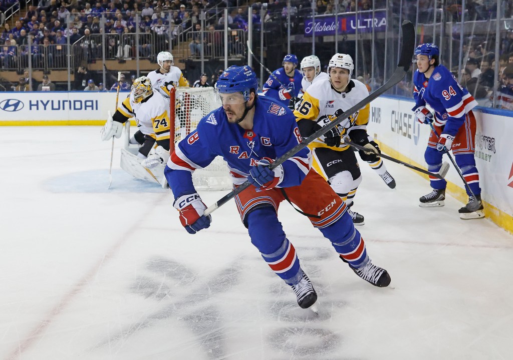 New York Rangers center J.T. Miller skates behind the net in a game against the Pittsburgh Penguins.
